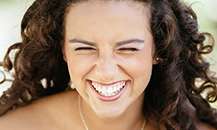 woman with curly hair smiling