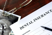 Dental insurance form resting on a table.