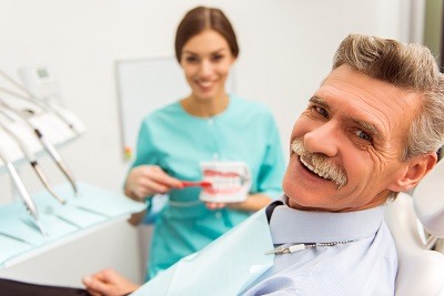 Smiling senior citizen man in dental chair