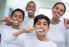 family brushing teeth