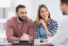 couple learning about dental implants with dentist