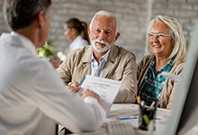 elderly couple at a dental implant consultation 