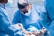 dentist performing dental implant surgery
