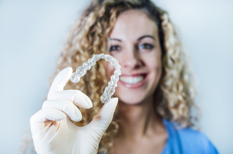 Woman holding Invisalign in Palm Beach Gardens