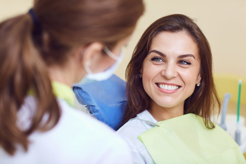 patient smiling after dental emergency in West Palm Beach